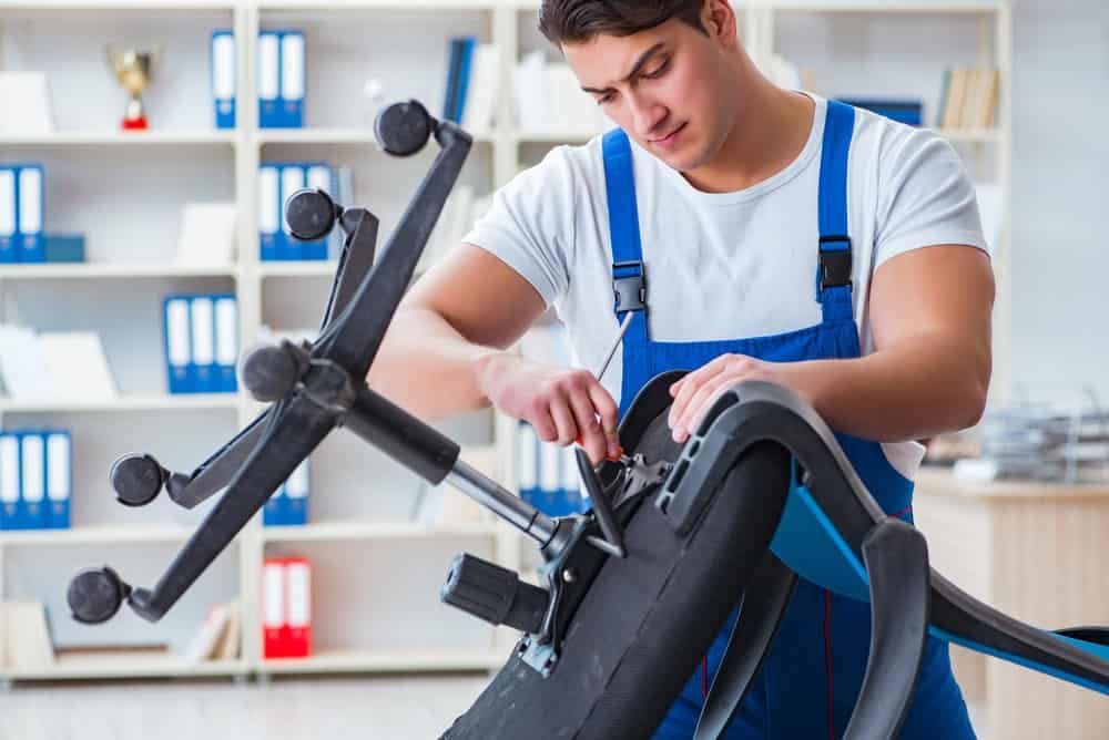 a man repairs office chair