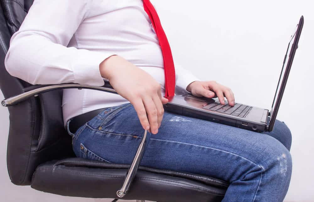 Office worker businessman with a laptop sitting on an office chair