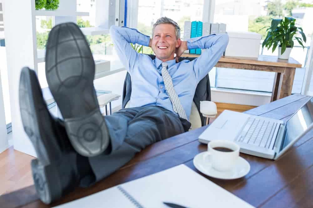 Businessman relaxing in a swivel office chair