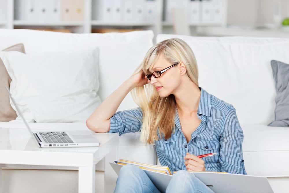 a girl doing homework to calculate the price of old office furniture