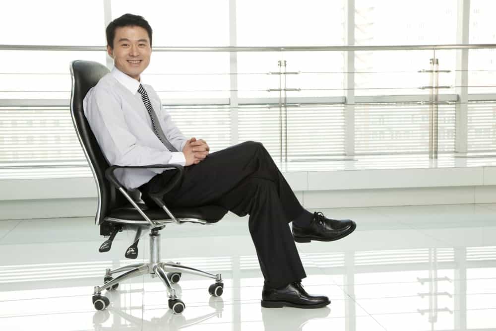 businessman sitting in standard office chair