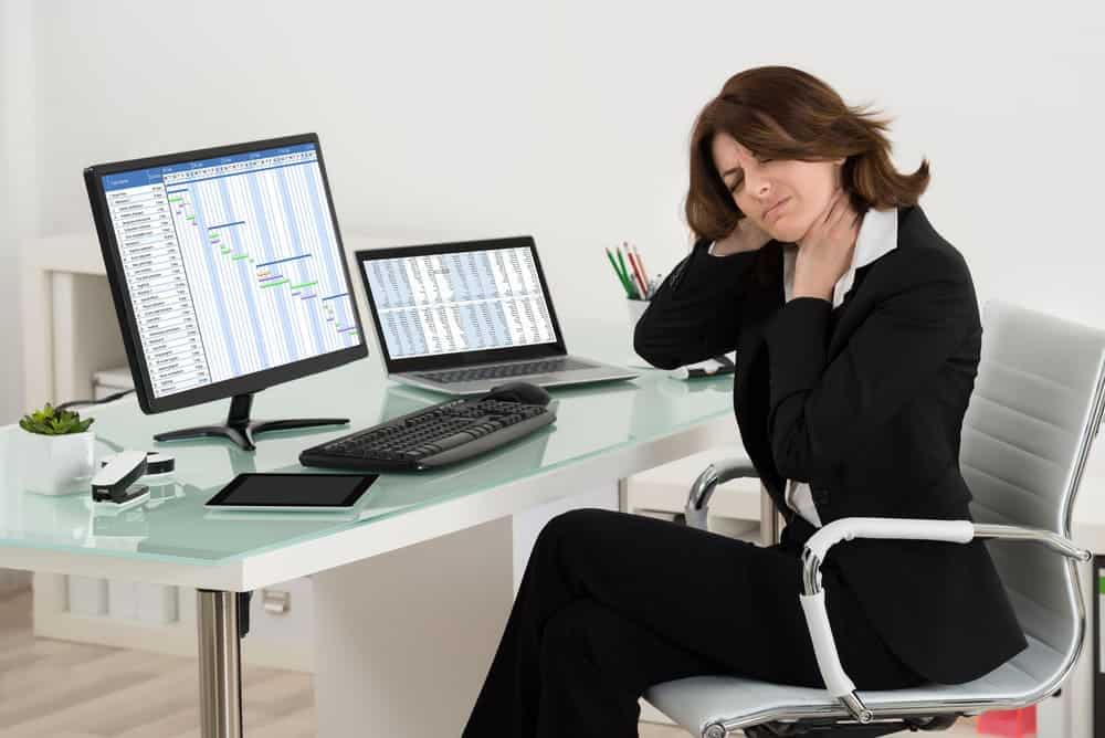 businesswoman on office chair having neck pain