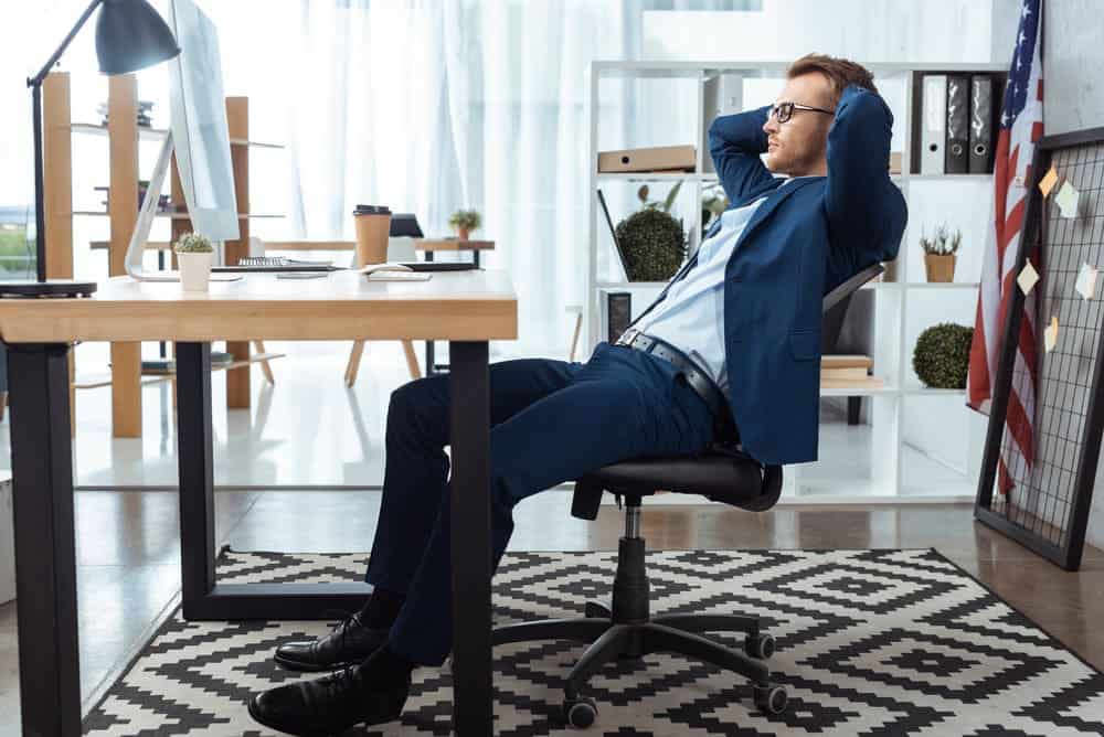 man sitting in a standard office chair