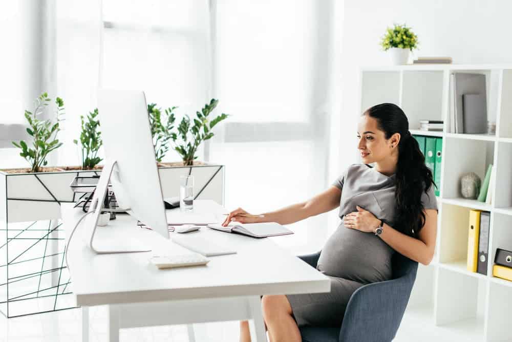 pregnant woman sit in office chair comfortably