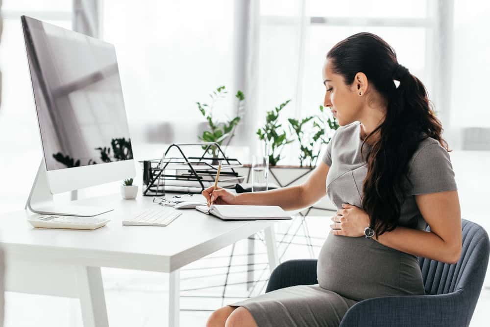 pregnant woman sitting in an office chair