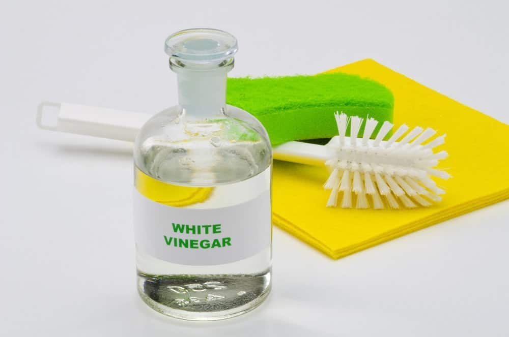 white vinegar, brush and sponge for cleaning leather office chair