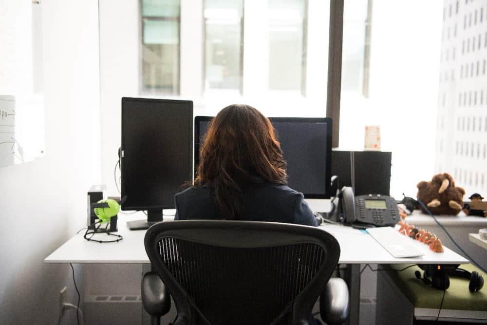 woman sitting in mid back office chair