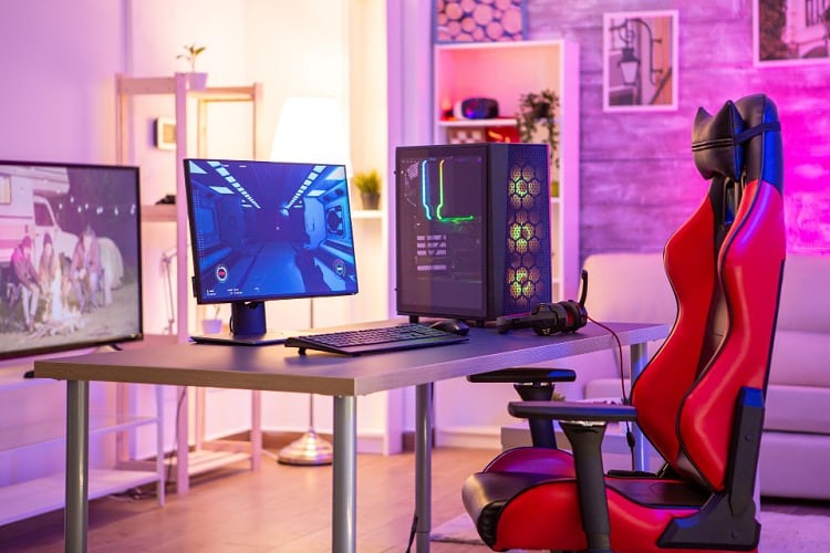 colorful room with a well set-up pc for gaming and gaming chair