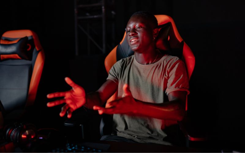 teenage boy sitting on a gaming chair 