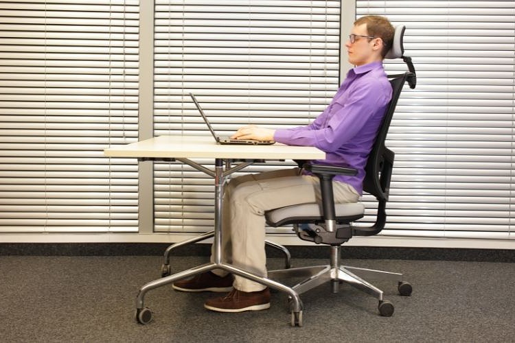 you should have lumbar support while sitting straight