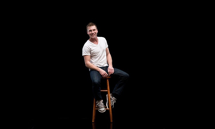 A man sitting on a stool