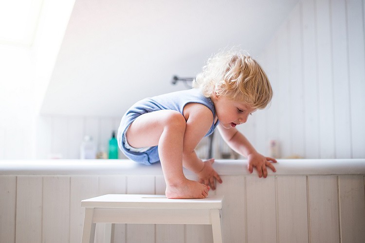 Toddler in danger situation while using stool