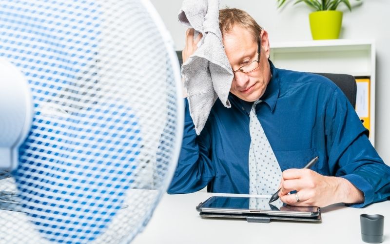 Business man sweating in his office