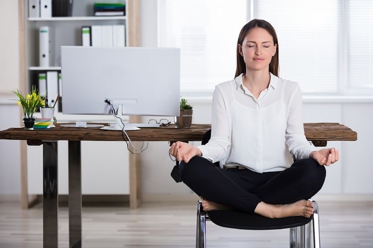 Business woman sitting on chair to meditate