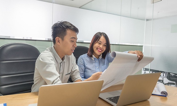 Coworkers talking comfortably with each other