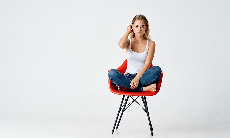 Girl sitting with feet on chair