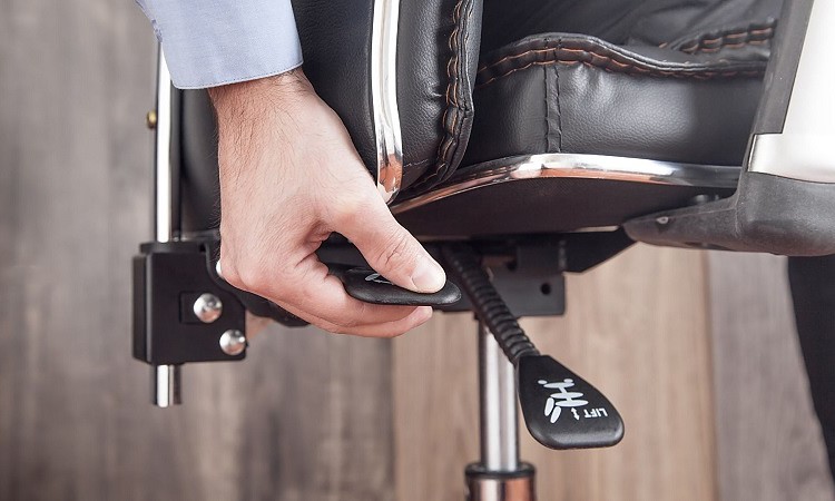 Male hand adjusts office chair