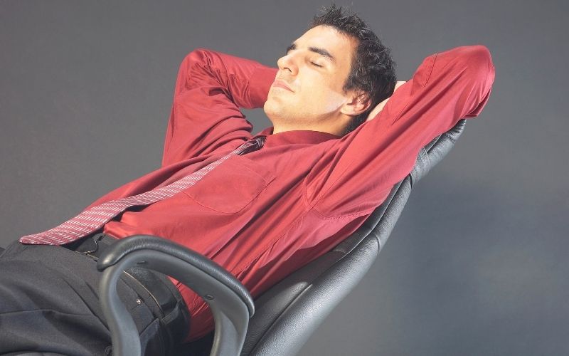 Man sit comfortably in reclining office chair