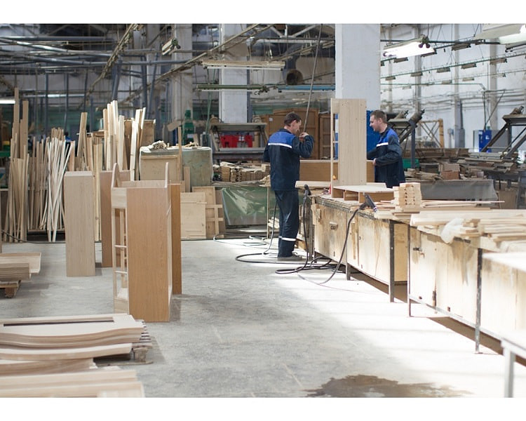 Two workers in office furniture factory