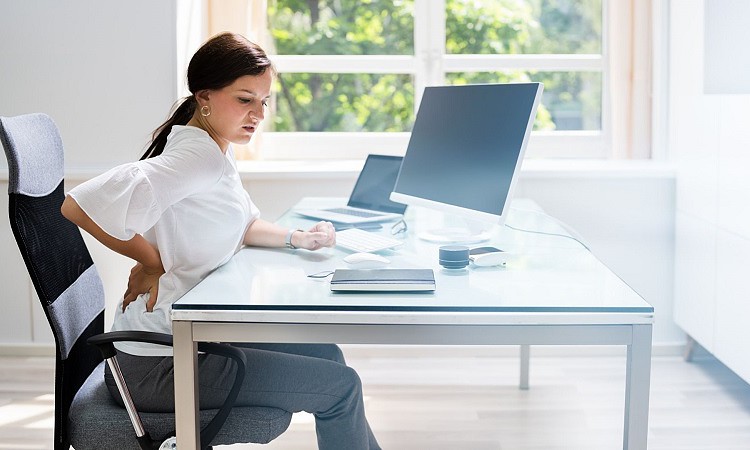 Woman has bad posture back pain while sitting