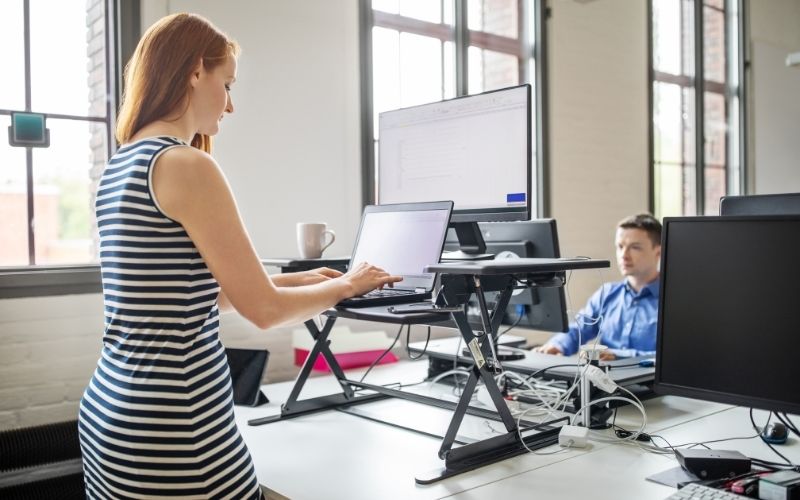 Woman working at ergonomic standing desk