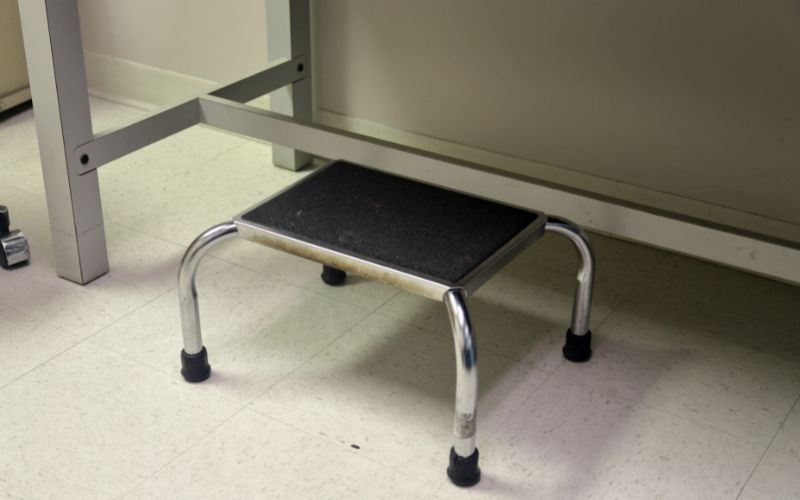 a gray footstool in a doctor's office