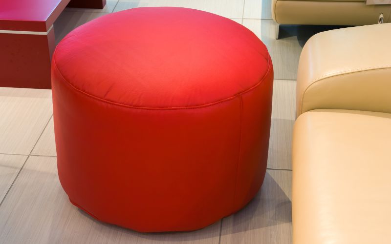 a red foot stool in the living room