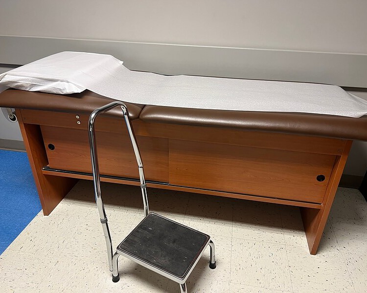examination table and bariatric stool in a doctor's office