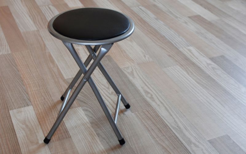 folding stool on wooden floor