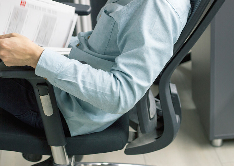 man sitting on an ergonomic chair with lumbar support