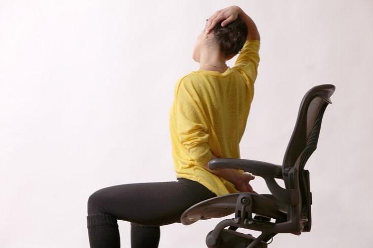 stretching your lower back in an office chair