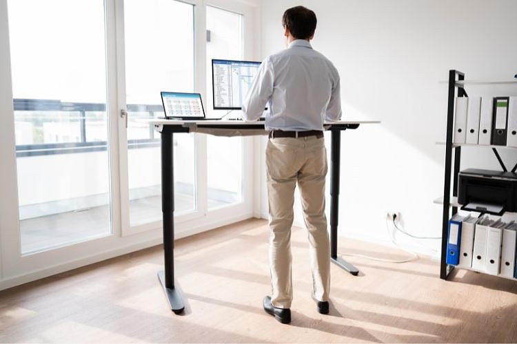 a man using standing desk for office work