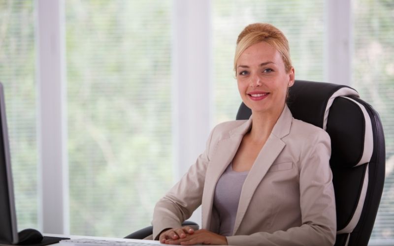 Business woman sitting comfortably in office chair