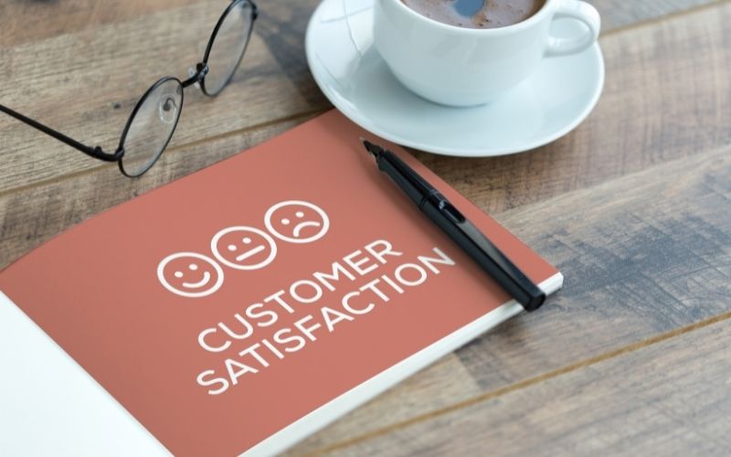 Customer Satisfaction notebook on coffee table