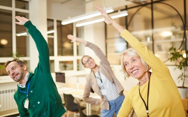 Employees exercise in office