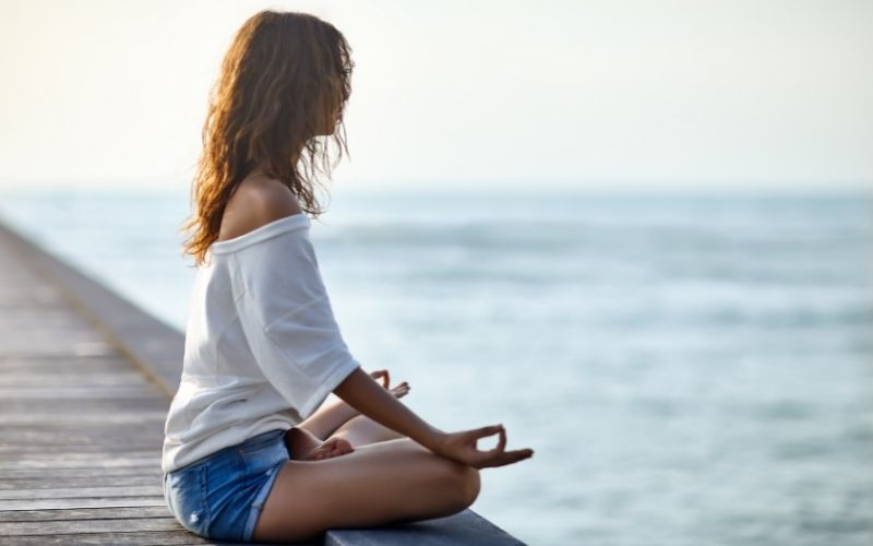 Girl meditating in lotus pose