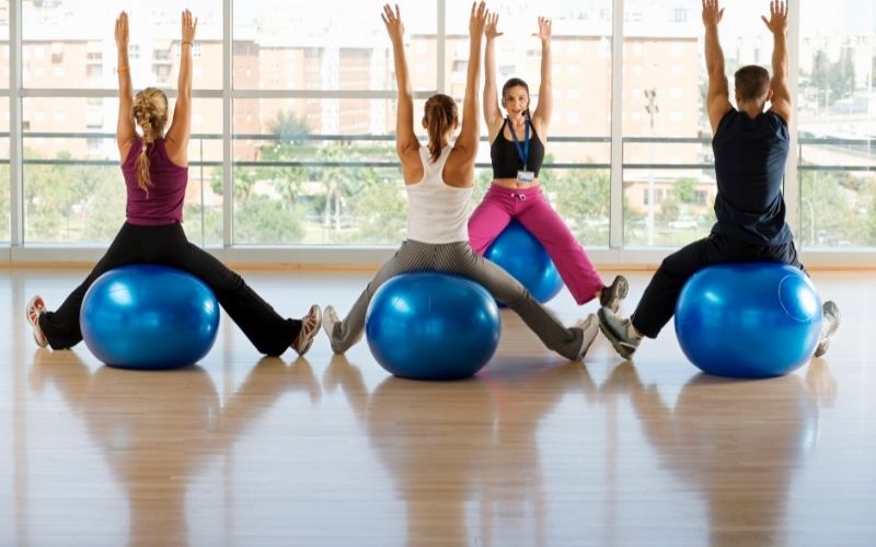 Group of people sitting on exercise balls to workout