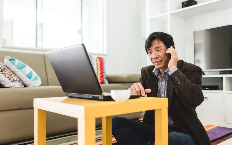 Japanese business man sitting on the floor in crossed legs