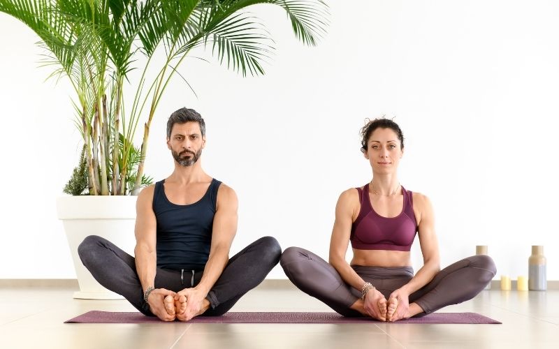 Man and woman sitting in butterfly pose