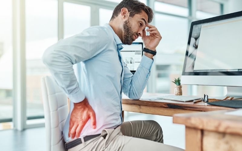 Man with lower body pain due to long time sitting