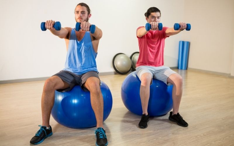 Men exercising on exercise balls