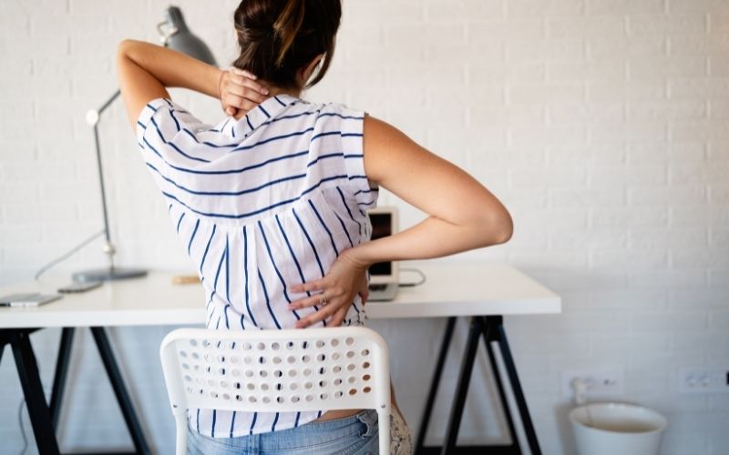 Woman experiences neck and back pain due to sitting on wrong chair for work
