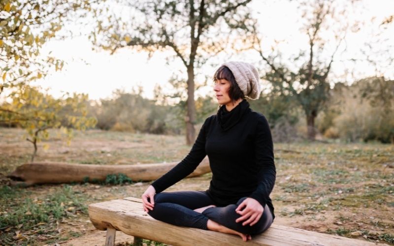 Woman meditating in a park