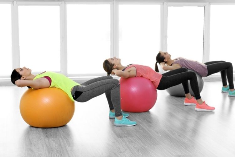 Women crunching on exercise balls