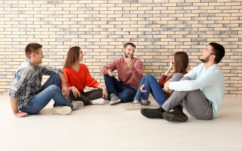 Young people sitting on the floor together