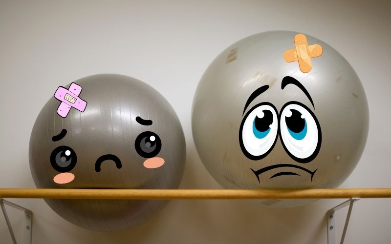 Exercise balls with sad faces and bandages