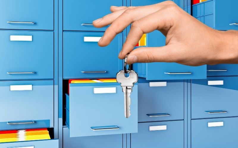 File Cabinet and a hand holding a key