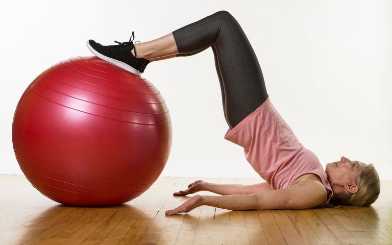 Glute bridge with exercise ball to help pelvic pain