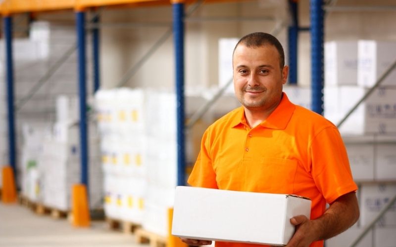 Manual worker holding a carton box package
