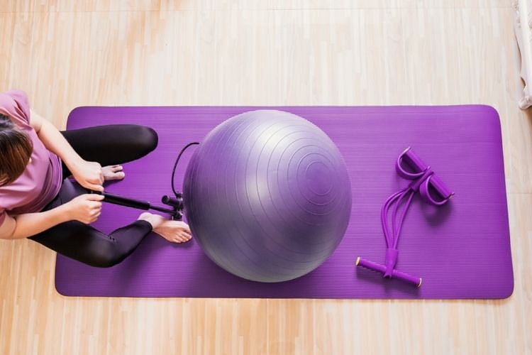 Woman inflating an exercise ball